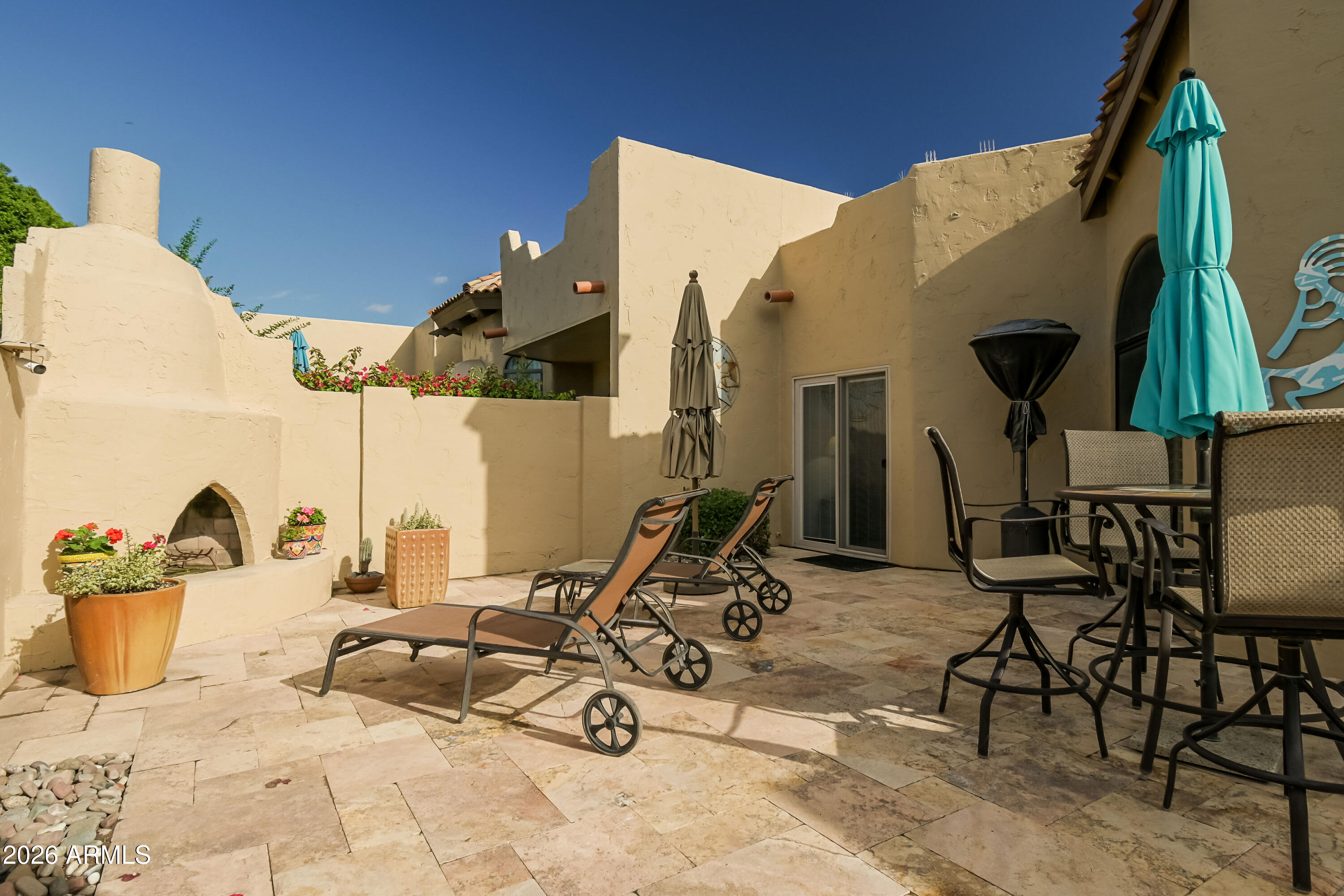 7955 East Chaparral Road, Unit 62 Scottsdale, AZ 85250 - Photo 22 of 38 a view of a patio with a dining table and chairs