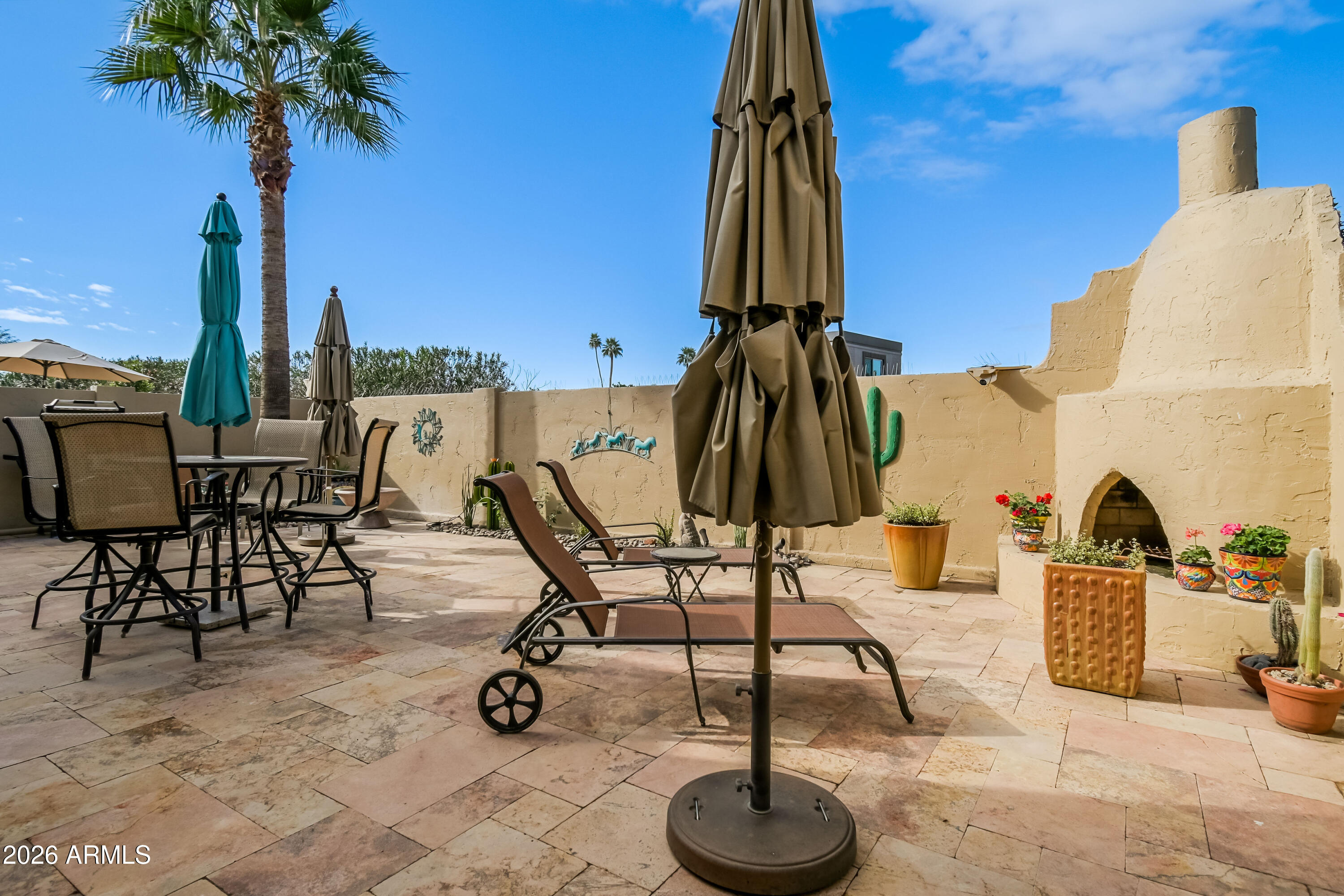7955 East Chaparral Road, Unit 62 Scottsdale, AZ 85250 - Photo 23 of 38 a view of a swimming pool with a lounge chair and palm trees