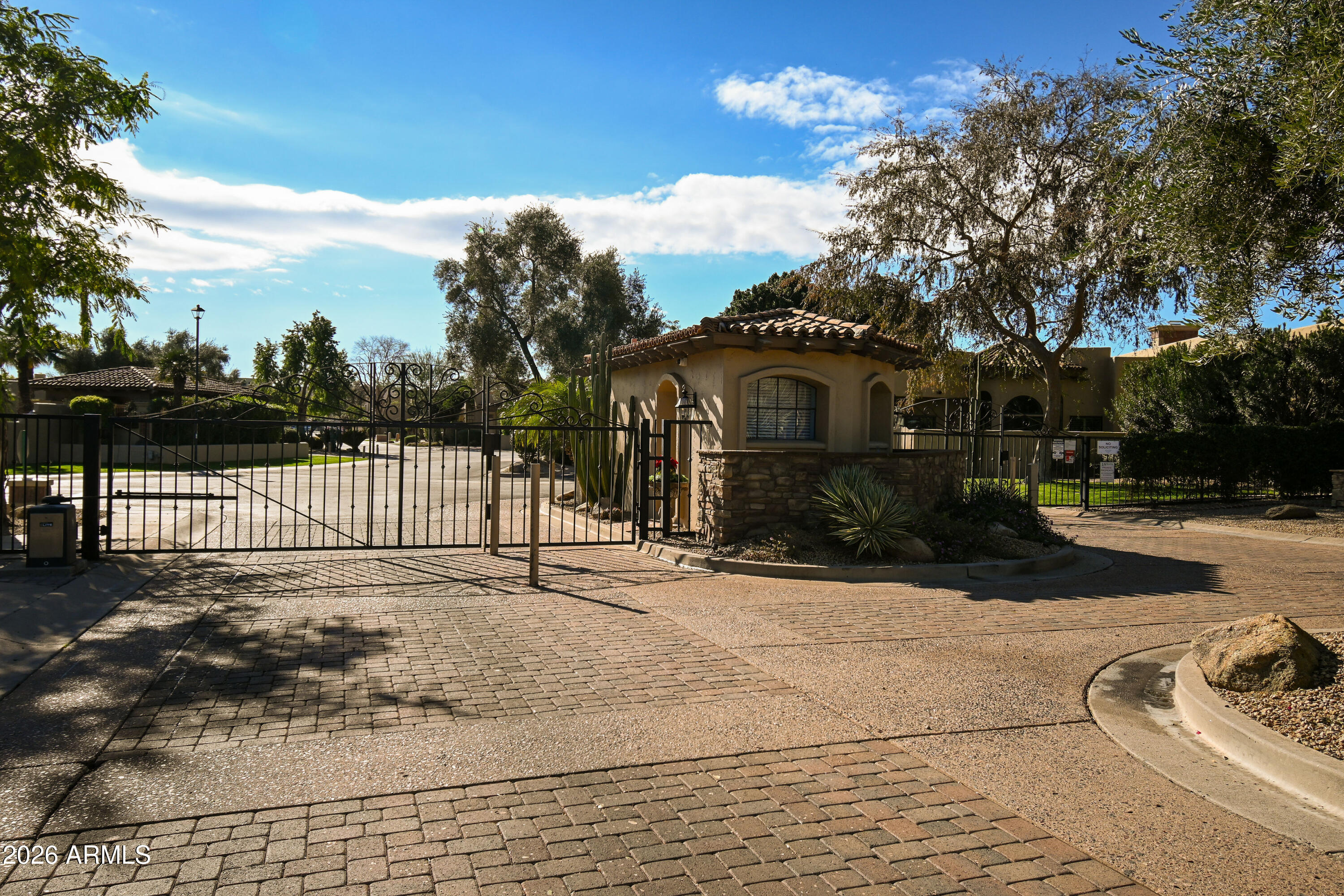 7955 East Chaparral Road, Unit 62 Scottsdale, AZ 85250 - Photo 25 of 38 a front view of a house with a yard