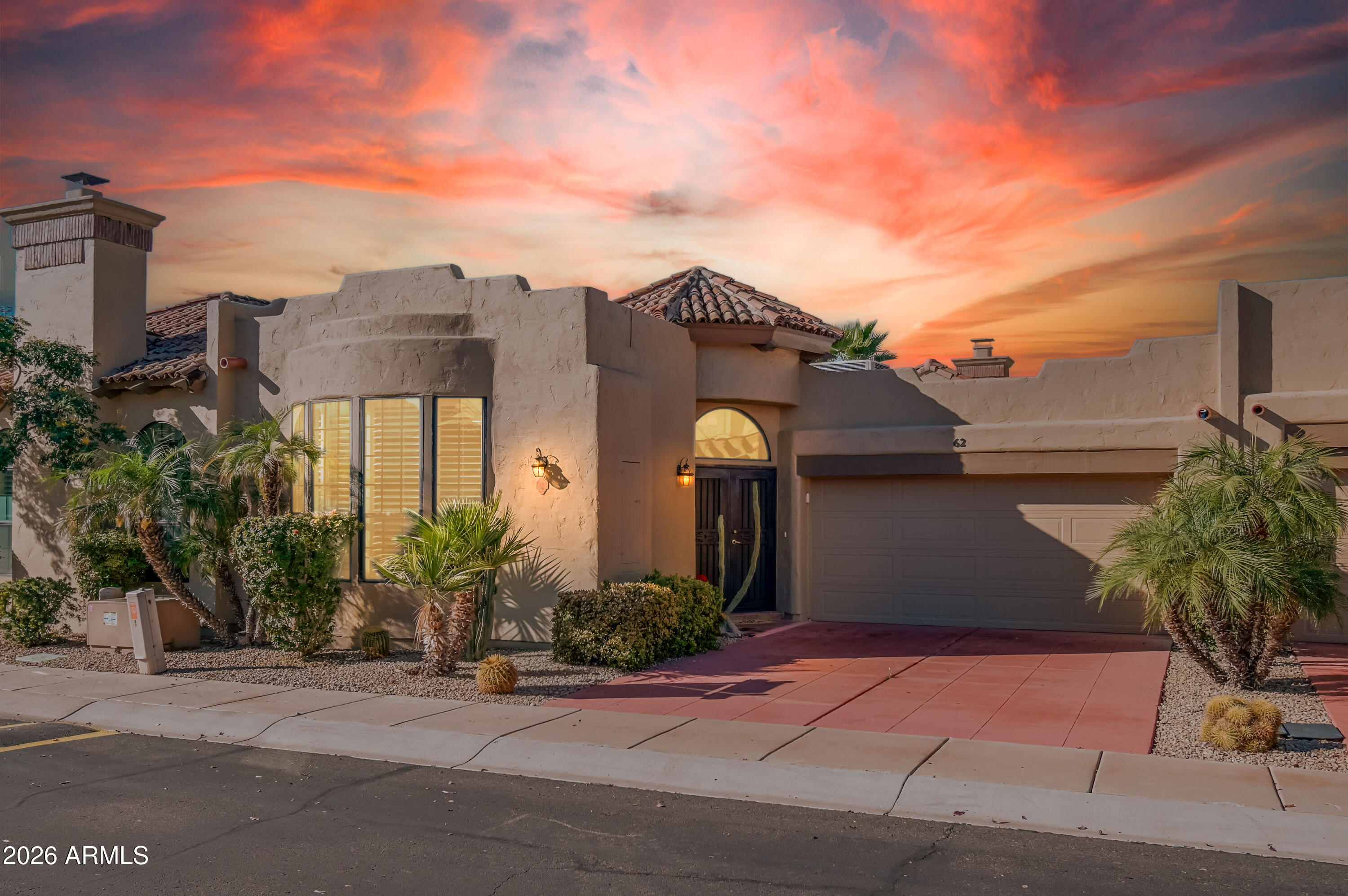 7955 East Chaparral Road, Unit 62 Scottsdale, AZ 85250 - Photo 29 of 38 a front view of a house with a yard