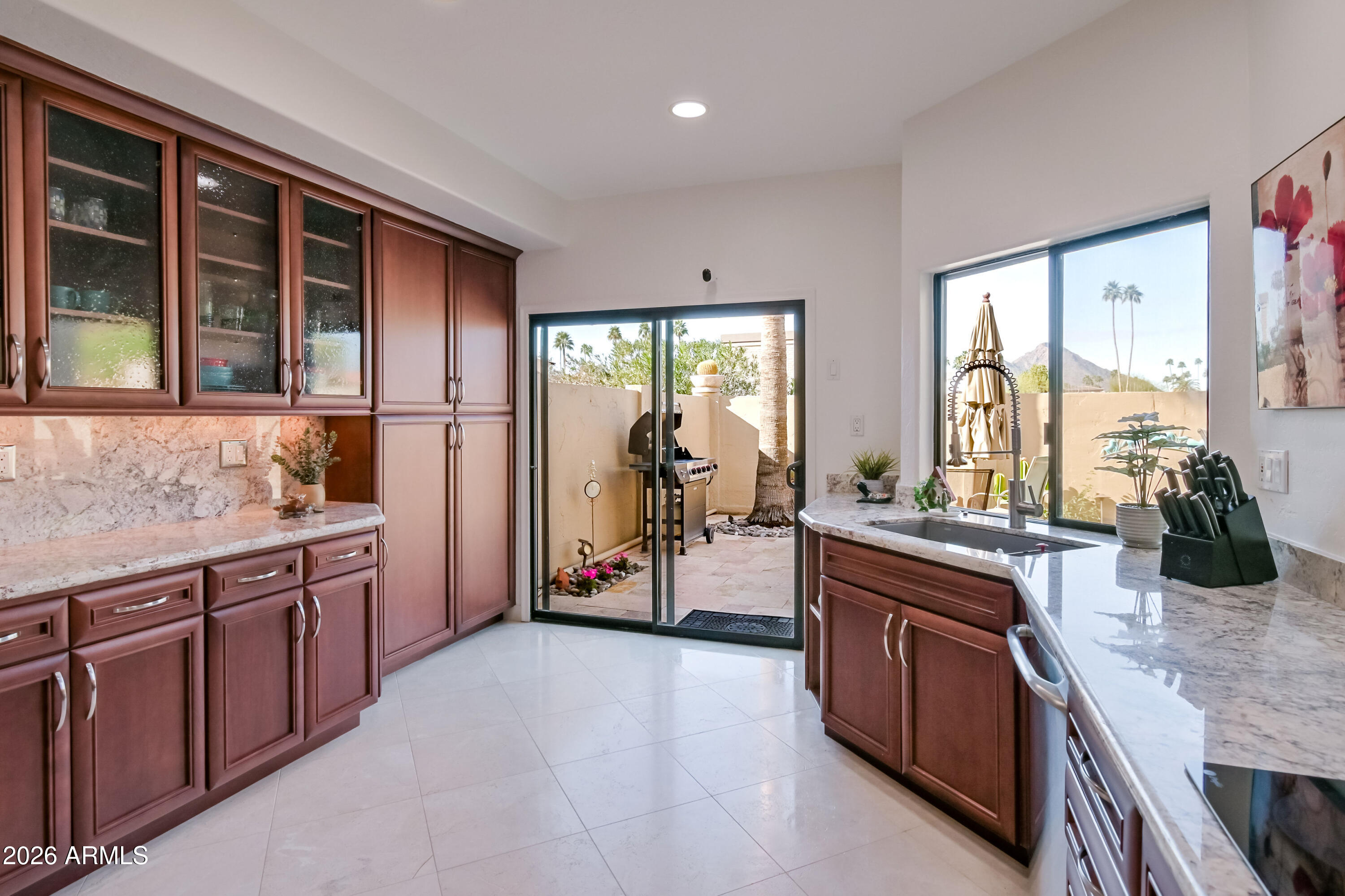 7955 East Chaparral Road, Unit 62 Scottsdale, AZ 85250 - Photo 3 of 38 a kitchen with stainless steel appliances granite countertop a sink and a refrigerator