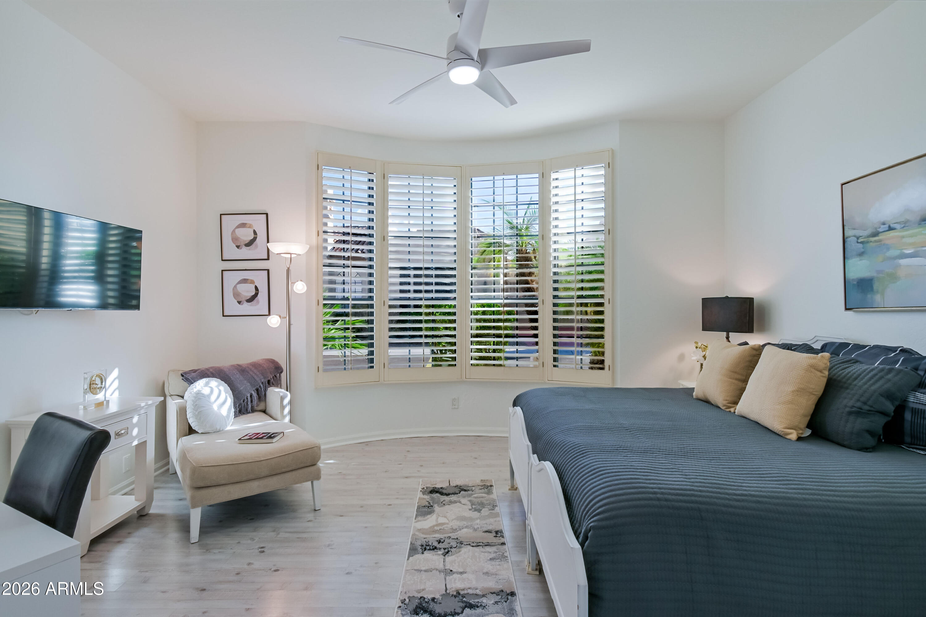 7955 East Chaparral Road, Unit 62 Scottsdale, AZ 85250 - Photo 6 of 38 a bedroom with a bed and wooden floor