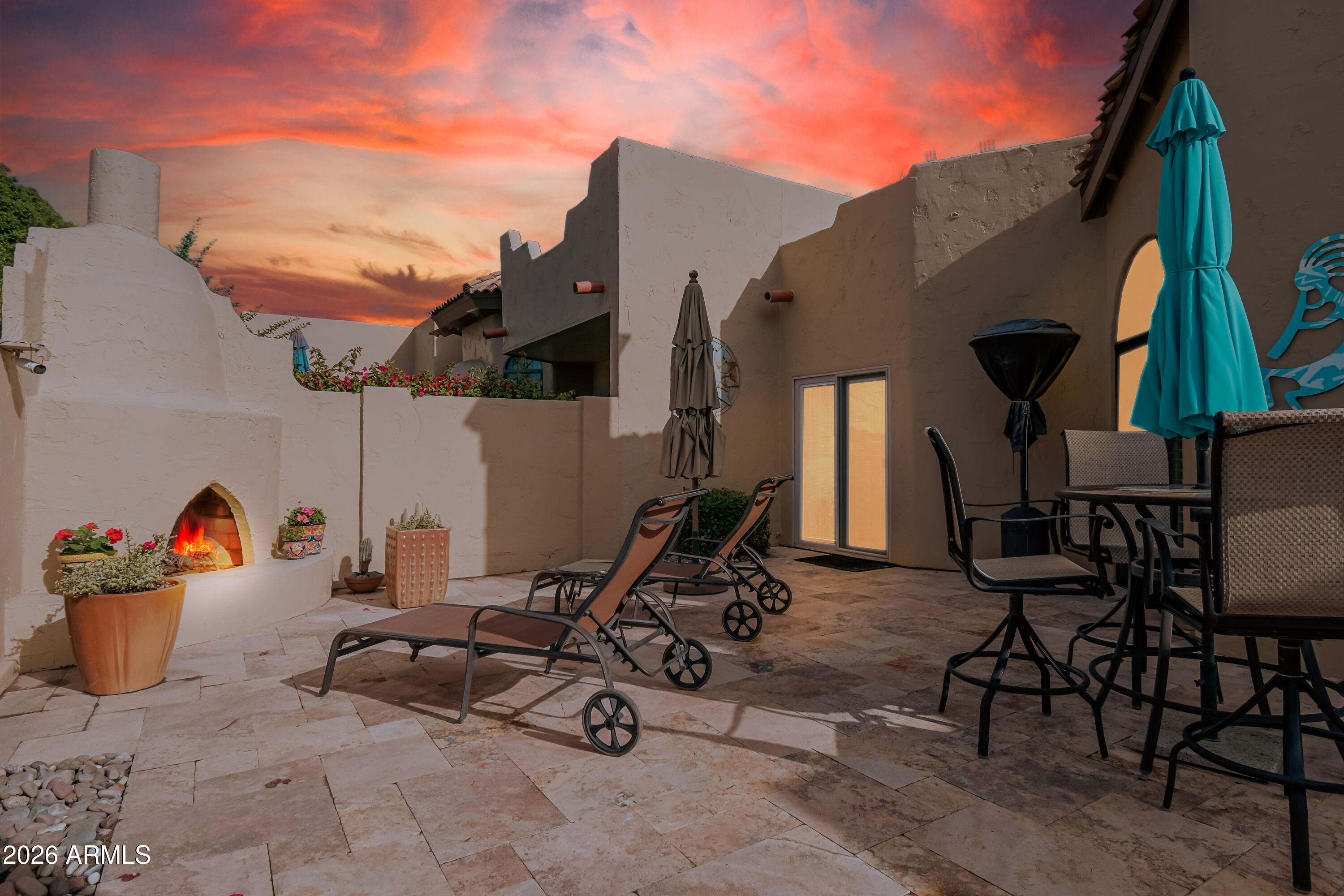 7955 East Chaparral Road, Unit 62 Scottsdale, AZ 85250 - Photo 7 of 38 a view of a chairs and table in backyard