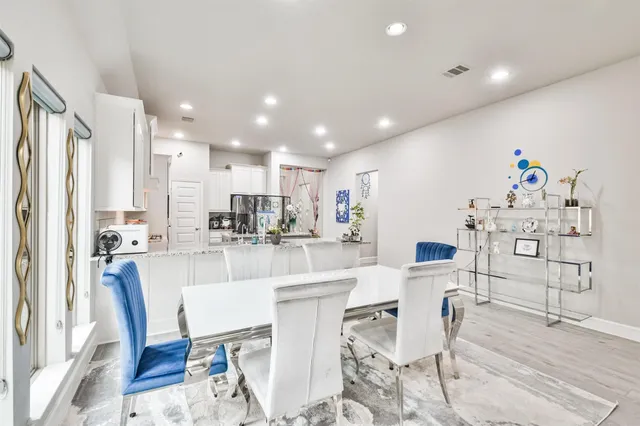 a kitchen with kitchen island a appliances and a dining table