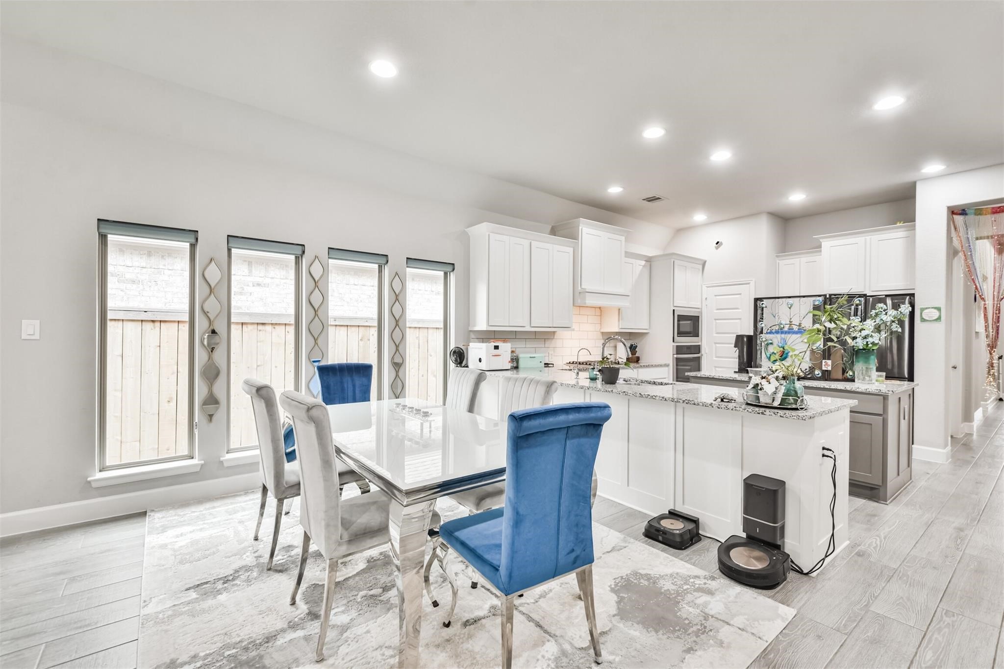 15018 Concho River Way Cypress, TX 77433 - Photo 13 of 34 a kitchen with a dining table chairs and refrigerator