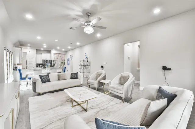 a living room with furniture and kitchen view