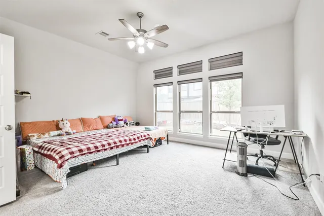 a bedroom with a bed a table and chair