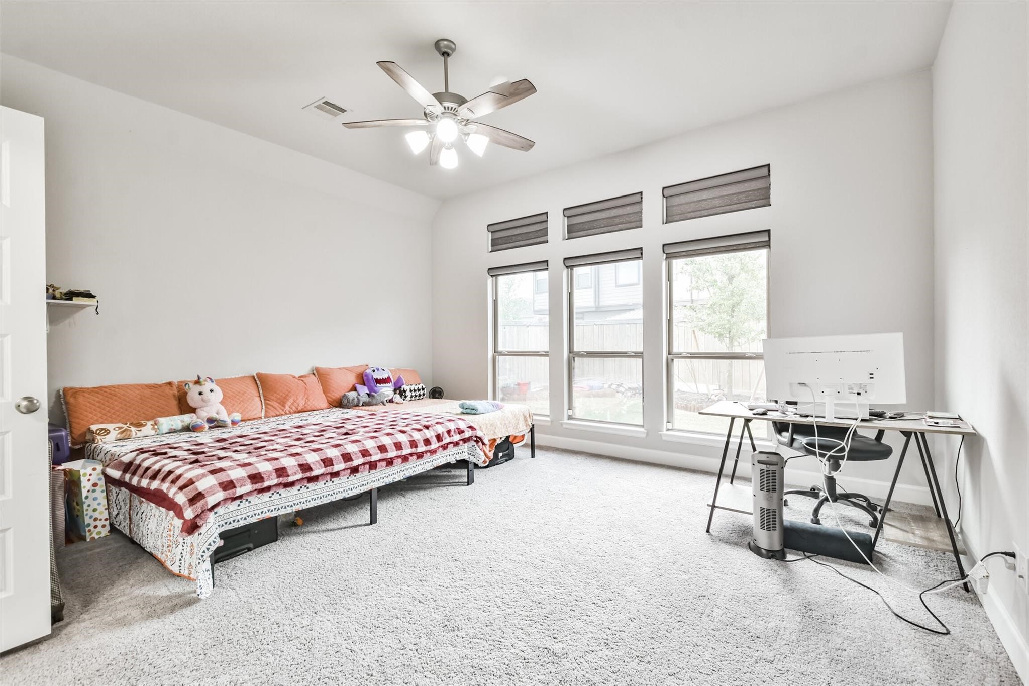 15018 Concho River Way Cypress, TX 77433 - Photo 18 of 34 a bedroom with a bed a table and chair