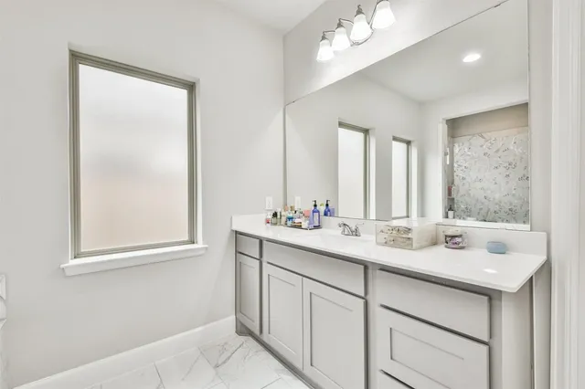 a bathroom with a sink double vanity and a mirror