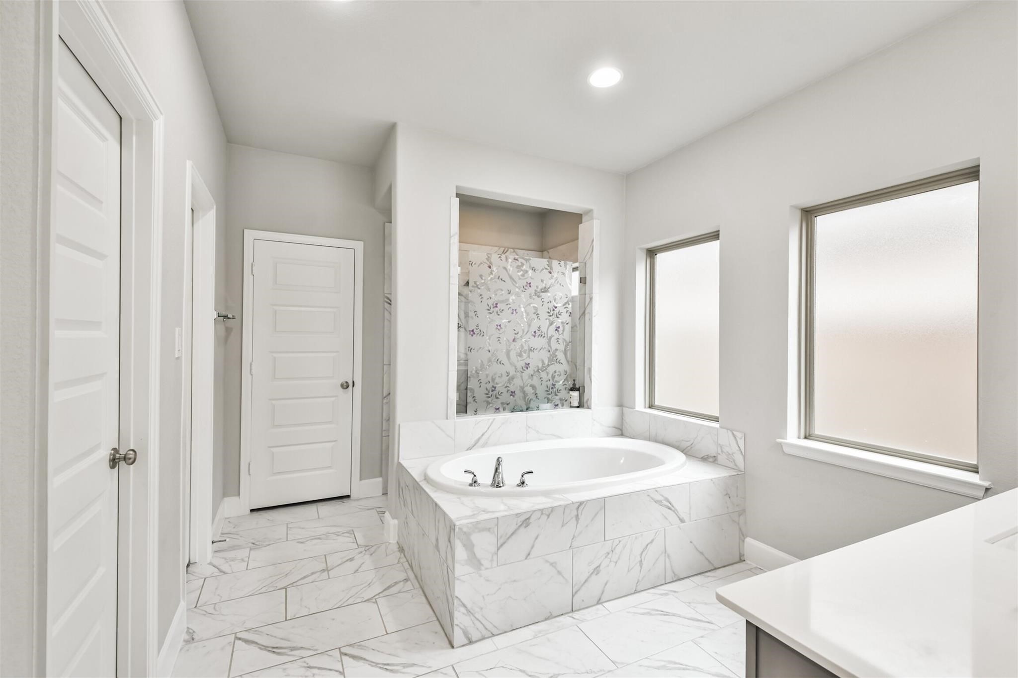 15018 Concho River Way Cypress, TX 77433 - Photo 21 of 34 a bathroom with a bathtub and a shower