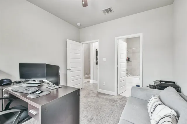 a bedroom with a workspace