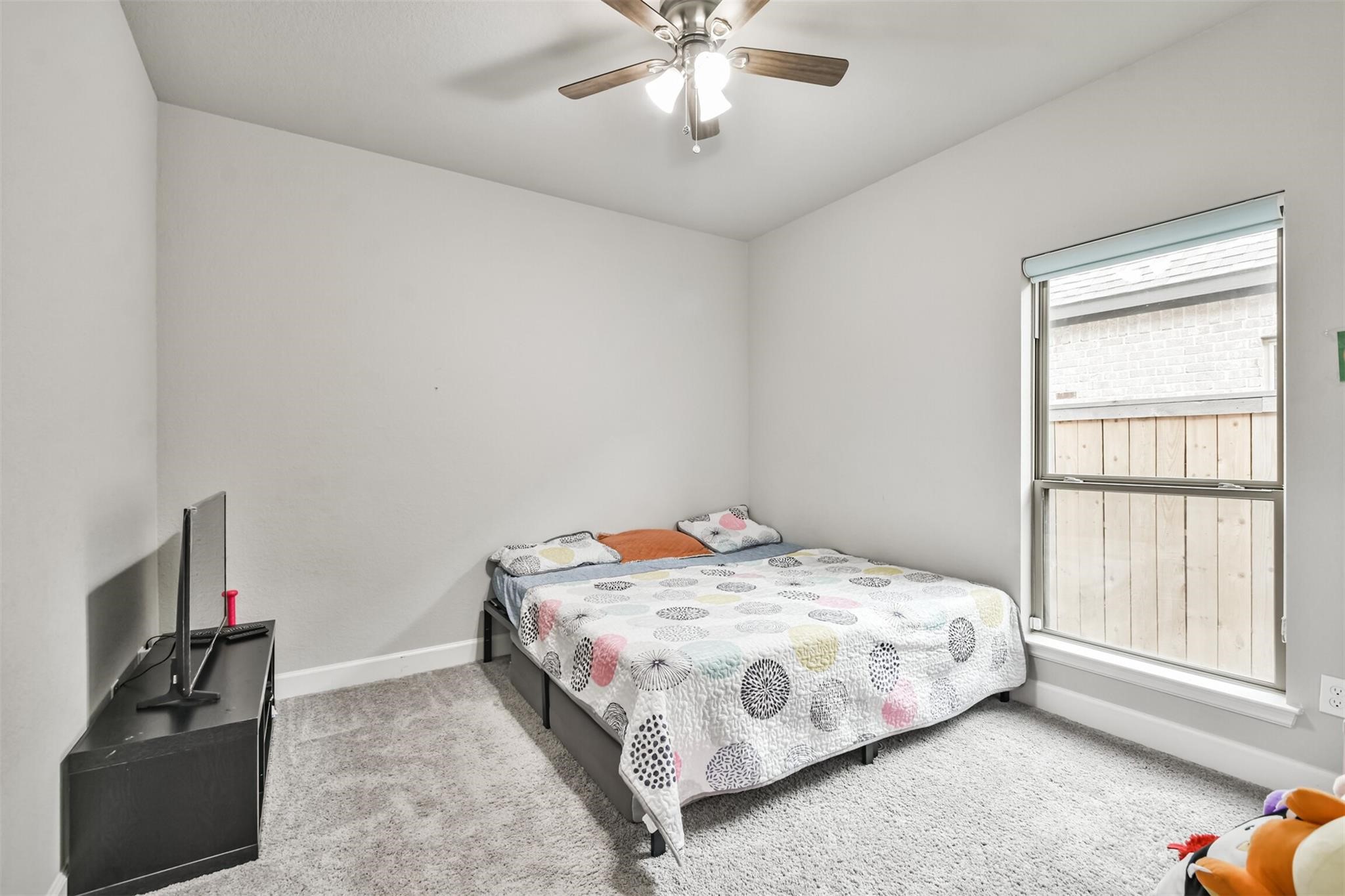 15018 Concho River Way Cypress, TX 77433 - Photo 27 of 34 a bedroom with a bed and a window