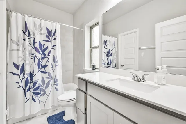 a room with a window and a white walls