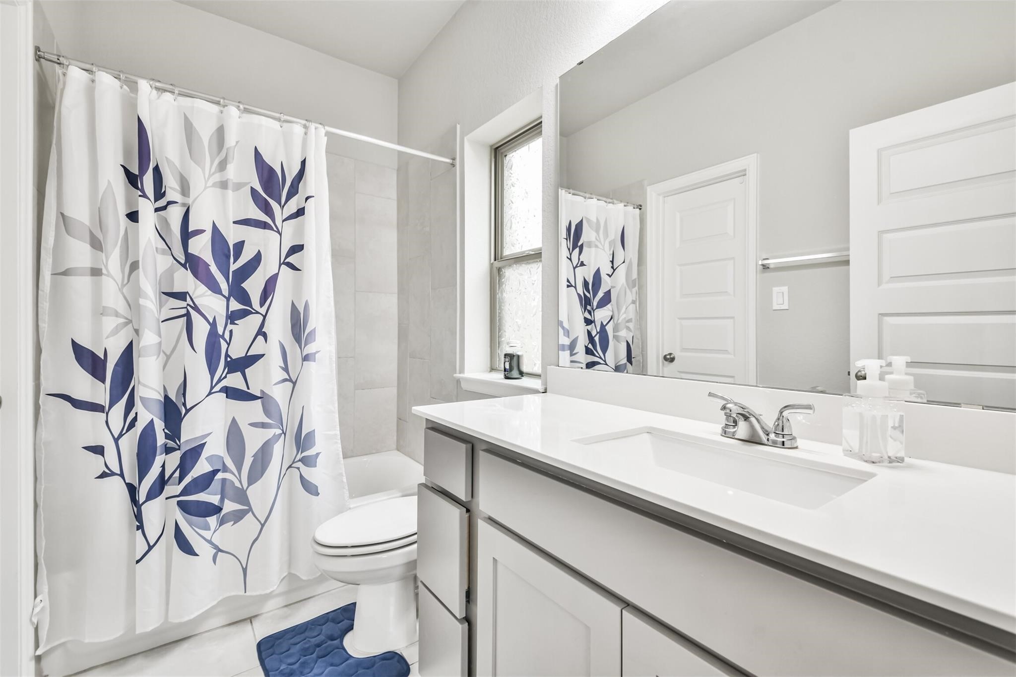 15018 Concho River Way Cypress, TX 77433 - Photo 30 of 34 a bathroom with a sink a toilet and a mirror