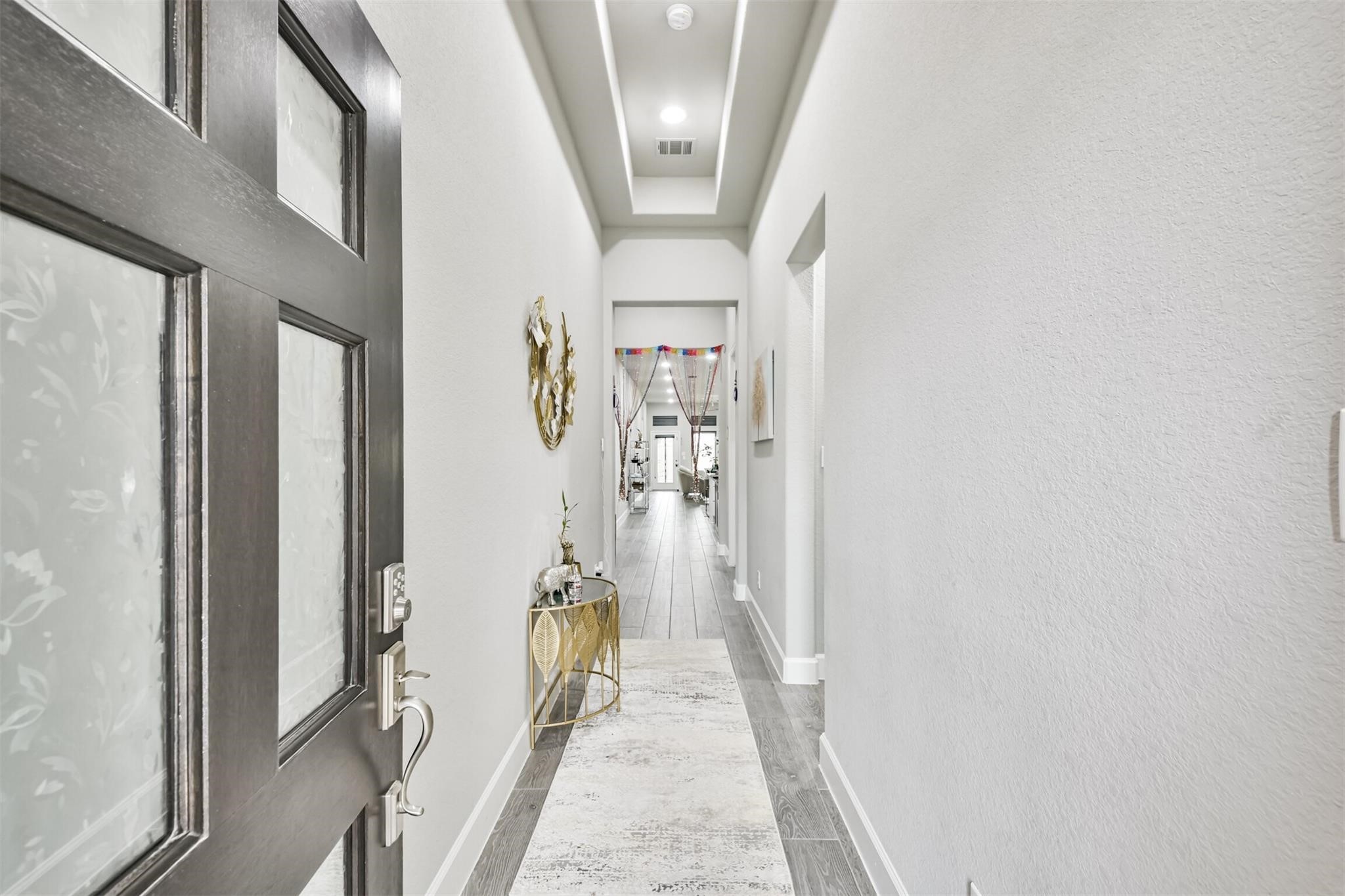 15018 Concho River Way Cypress, TX 77433 - Photo 4 of 34 a view of a hallway with wooden floor and staircase