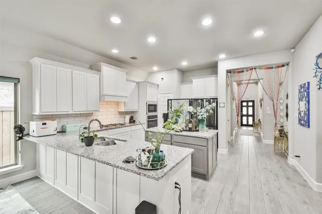 a kitchen with stainless steel appliances kitchen island granite countertop a sink and cabinets