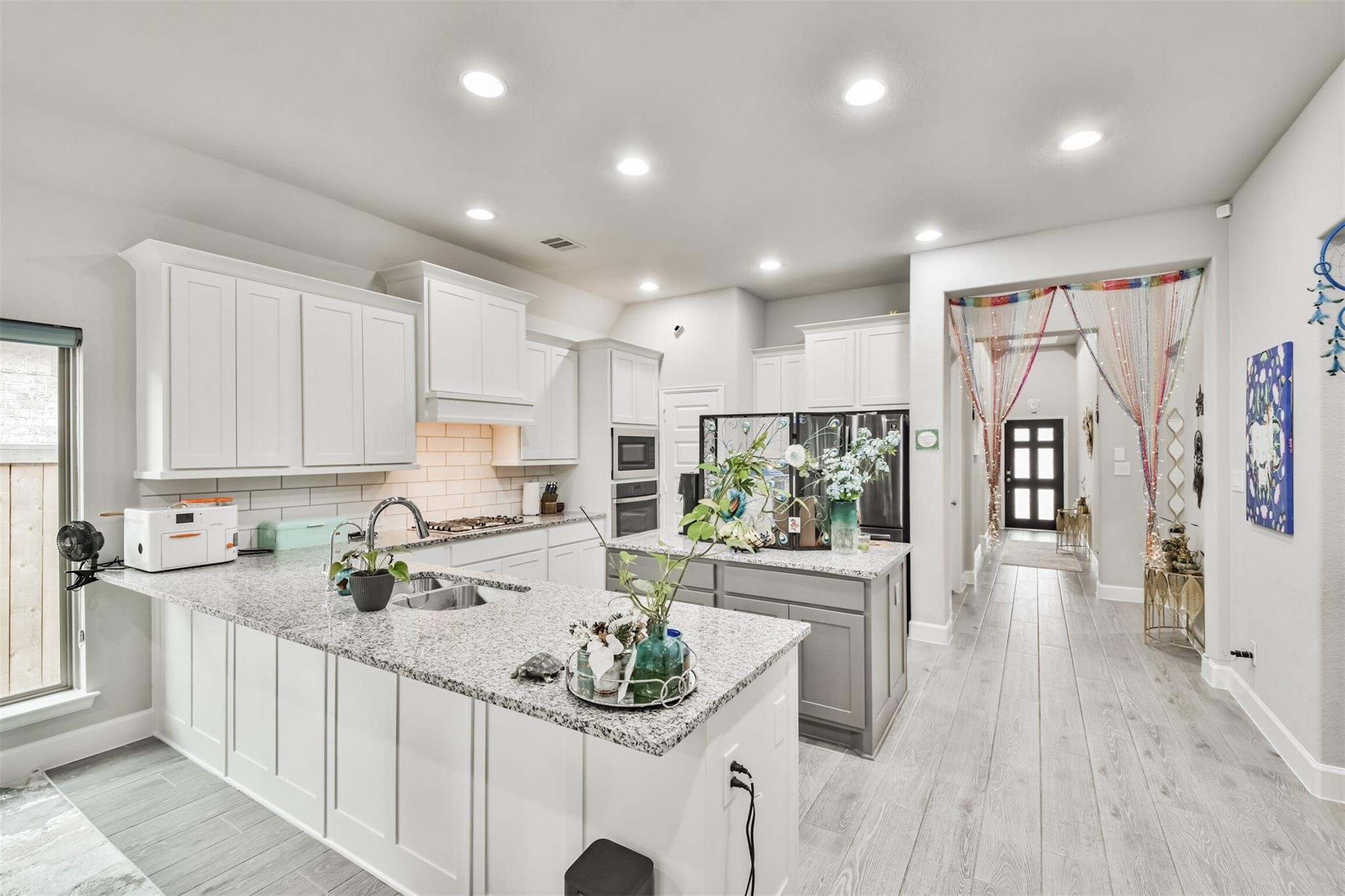 15018 Concho River Way Cypress, TX 77433 - Photo 5 of 34 a kitchen with stainless steel appliances kitchen island granite countertop a sink and cabinets