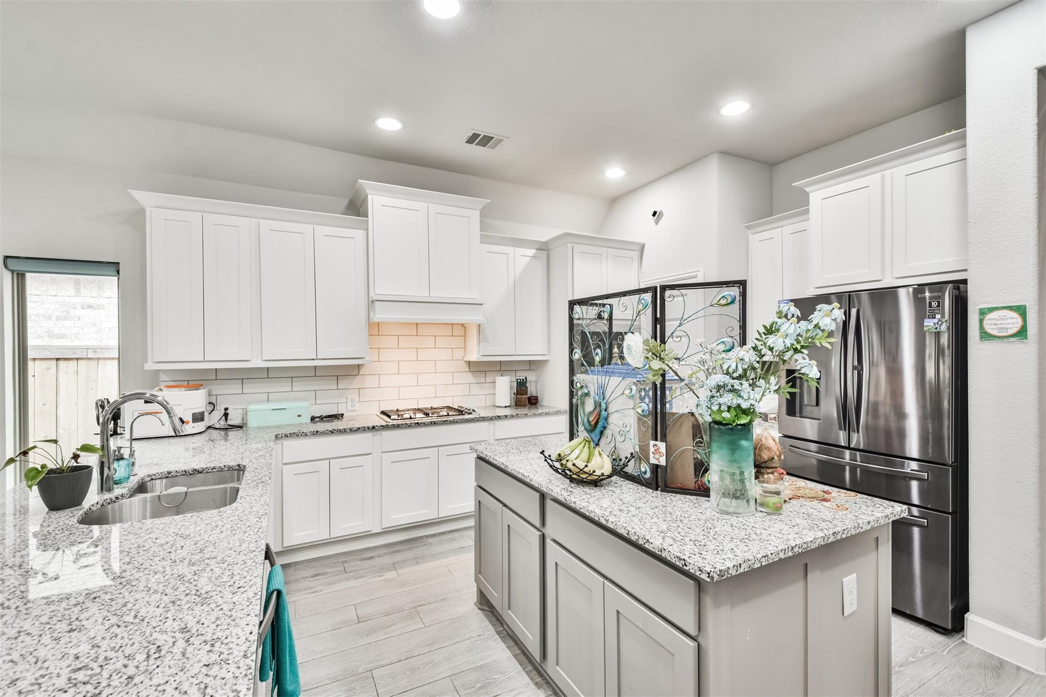 15018 Concho River Way Cypress, TX 77433 - Photo 7 of 34 a kitchen with stainless steel appliances granite countertop a sink stove and refrigerator