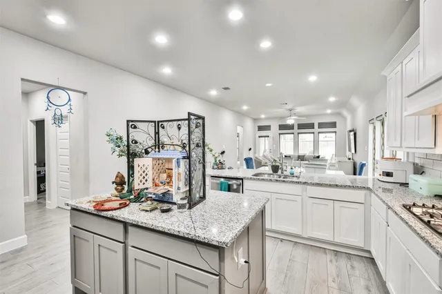 a kitchen with lots of counter top space sink and stainless steel appliances
