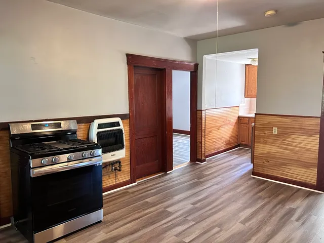 a kitchen with wooden floors and a stove