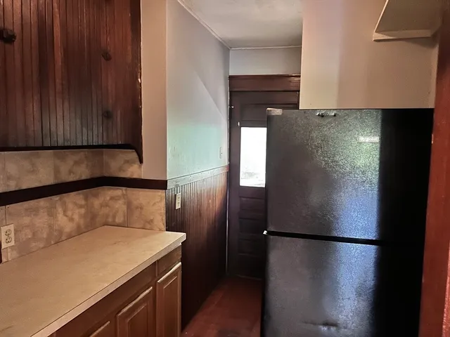 a kitchen with refrigerator and cabinet
