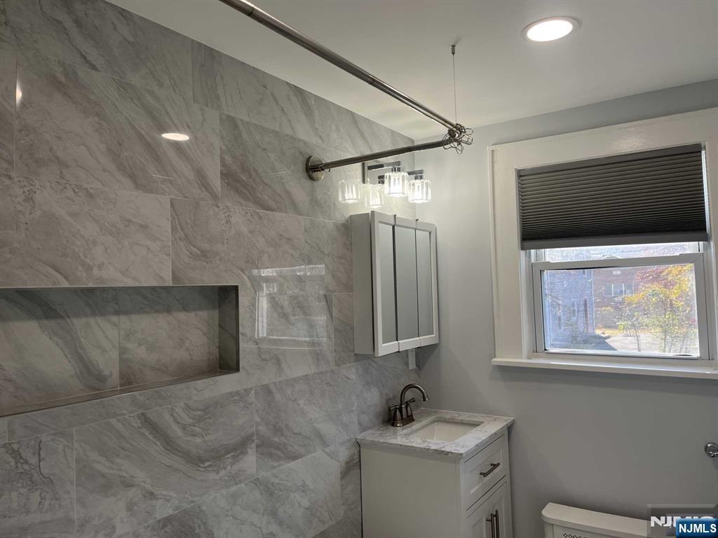 212 Walton Street, Unit 2 Ridgewood, NJ 07450 - Photo 15 of 27 a bathroom with a sink and a mirror