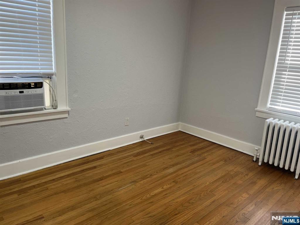 212 Walton Street, Unit 2 Ridgewood, NJ 07450 - Photo 16 of 27 a view of empty room with wooden floor and fan