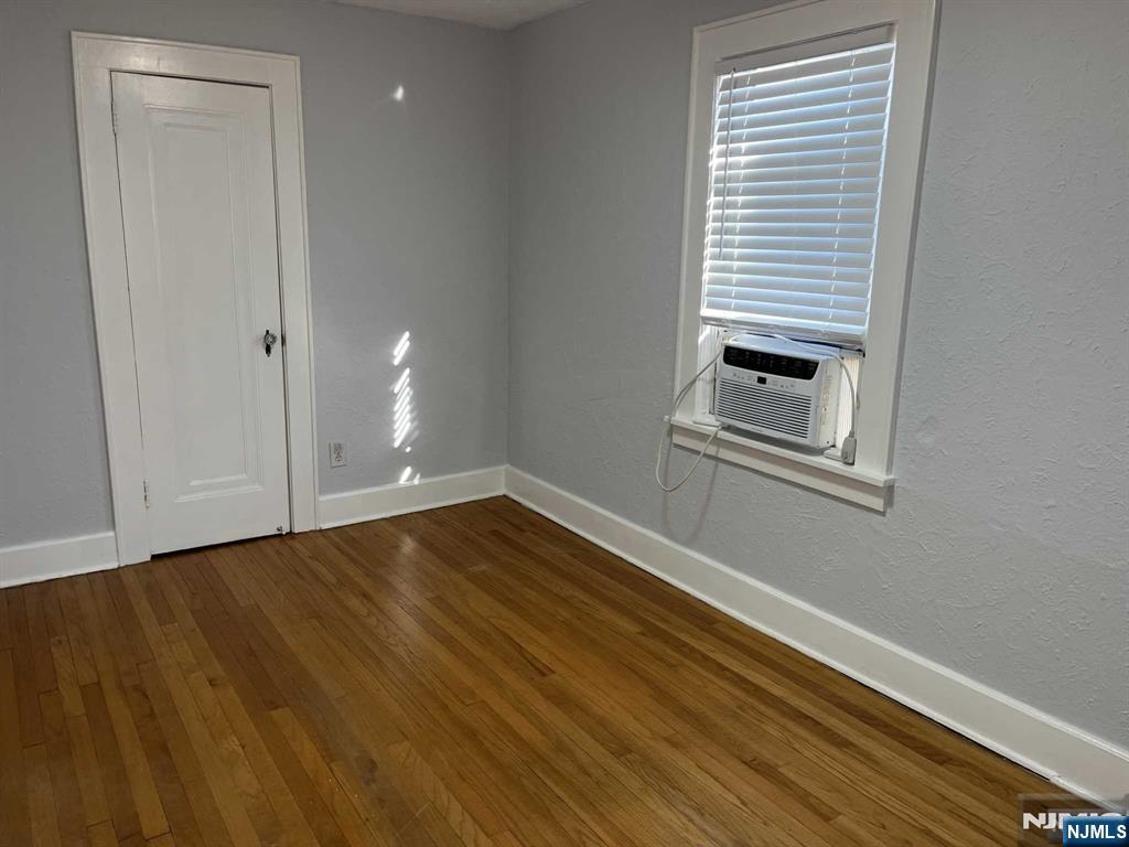 212 Walton Street, Unit 2 Ridgewood, NJ 07450 - Photo 17 of 27 a view of an empty room with wooden floor and a window