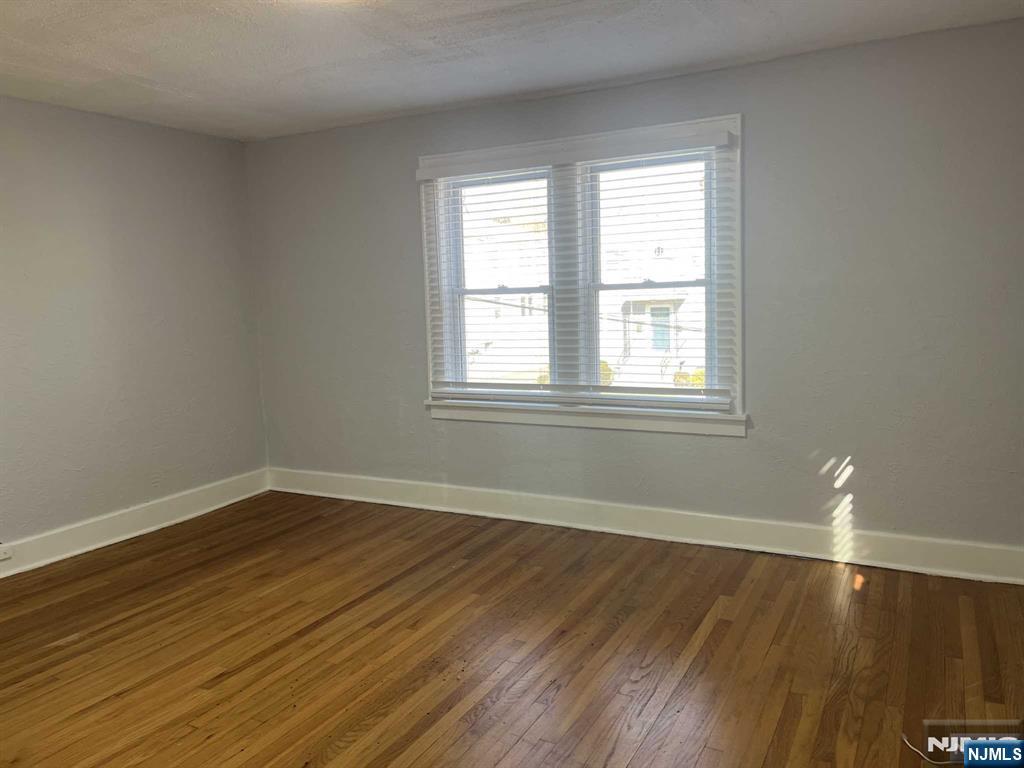 212 Walton Street, Unit 2 Ridgewood, NJ 07450 - Photo 20 of 27 an empty room with wooden floor and windows
