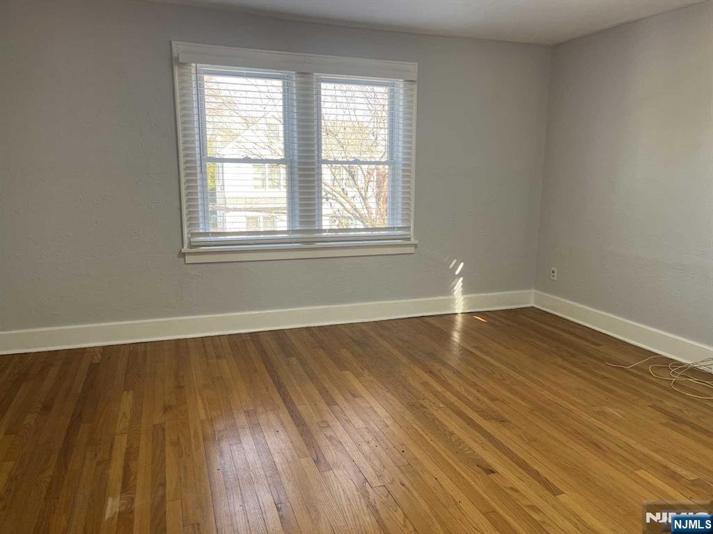 212 Walton Street, Unit 2 Ridgewood, NJ 07450 - Photo 21 of 27 wooden floor in an empty room with a window