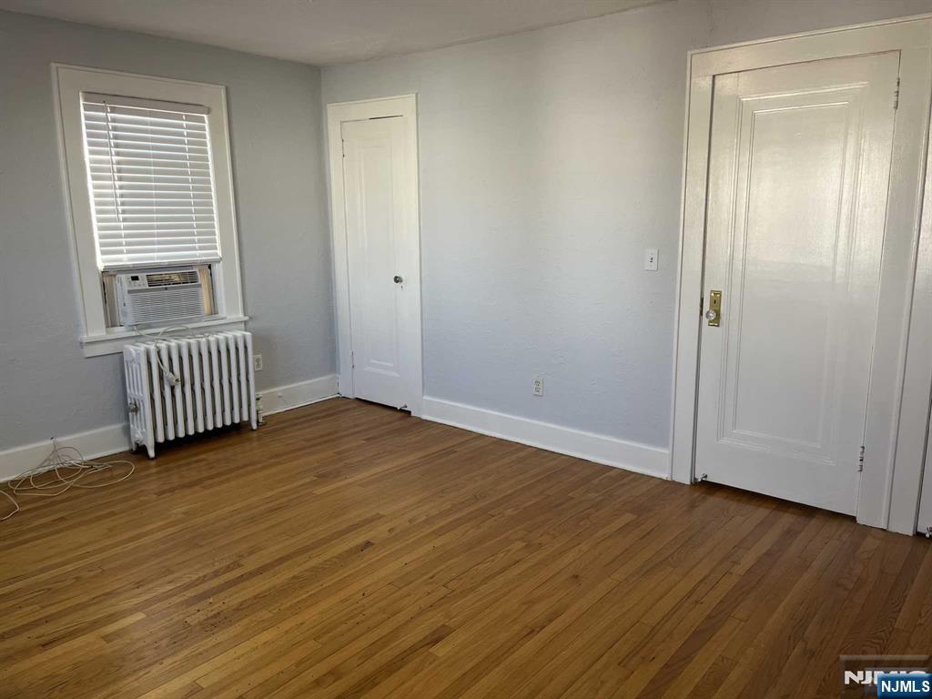 212 Walton Street, Unit 2 Ridgewood, NJ 07450 - Photo 22 of 27 an empty room with wooden floor and windows