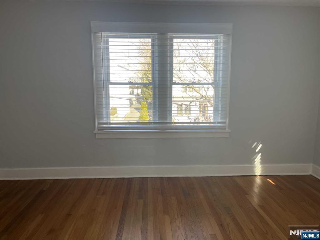 212 Walton Street, Unit 2 Ridgewood, NJ 07450 - Photo 23 of 27 a view of an empty room with wooden floor and a window