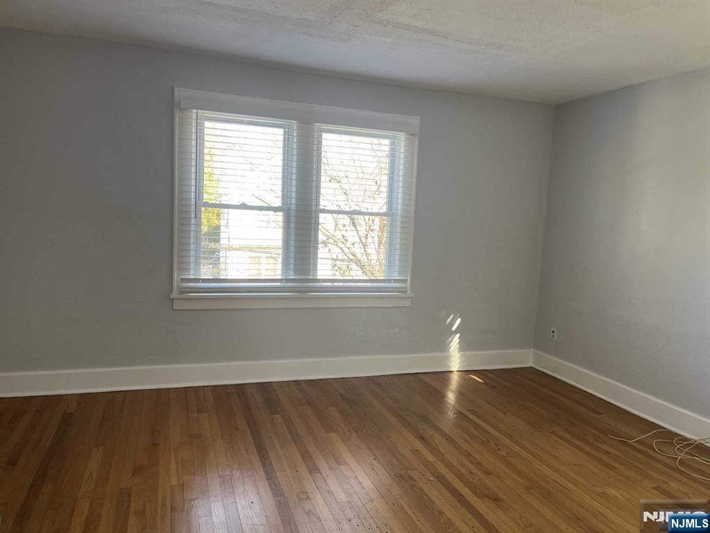 212 Walton Street, Unit 2 Ridgewood, NJ 07450 - Photo 24 of 27 a view of empty room with wooden floor and fan