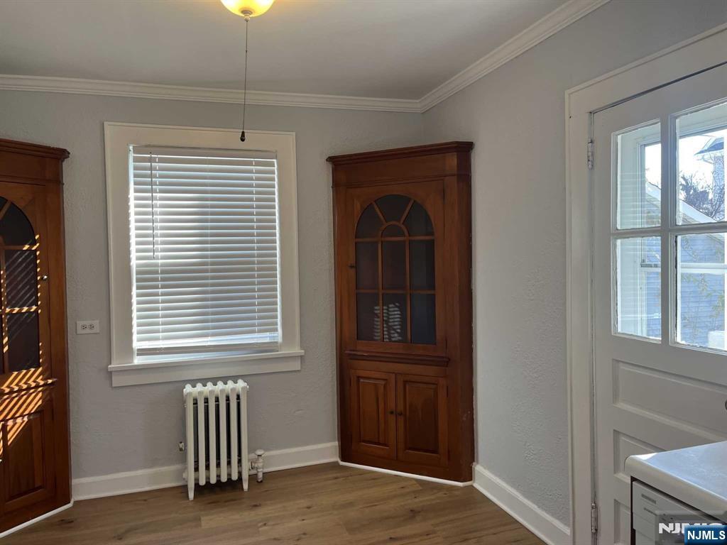 212 Walton Street, Unit 2 Ridgewood, NJ 07450 - Photo 6 of 27 an empty room with wooden floor and windows