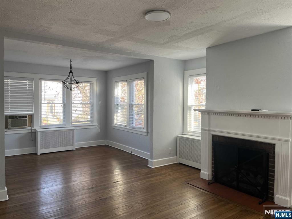 212 Walton Street, Unit 2 Ridgewood, NJ 07450 - Photo 7 of 27 an empty room with wooden floor fireplace and windows