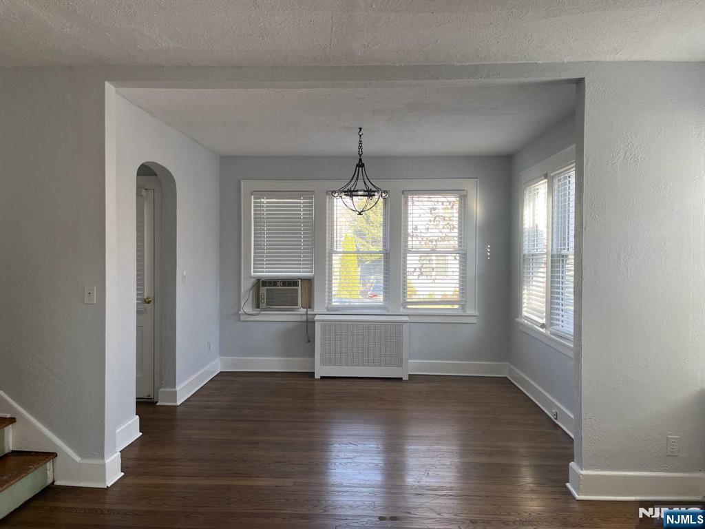 212 Walton Street, Unit 2 Ridgewood, NJ 07450 - Photo 8 of 27 an empty room with wooden floor and windows