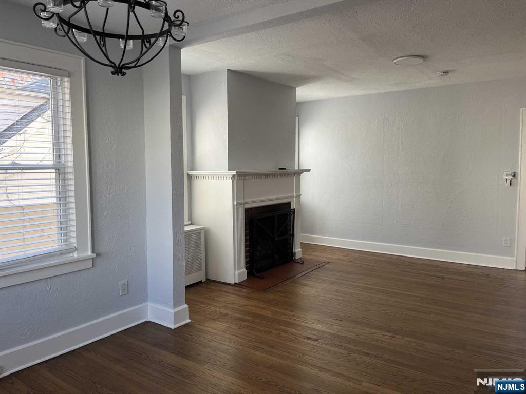 212 Walton Street, Unit 2 Ridgewood, NJ 07450 - Photo 10 of 27 a view of a room with wooden floor and fireplace