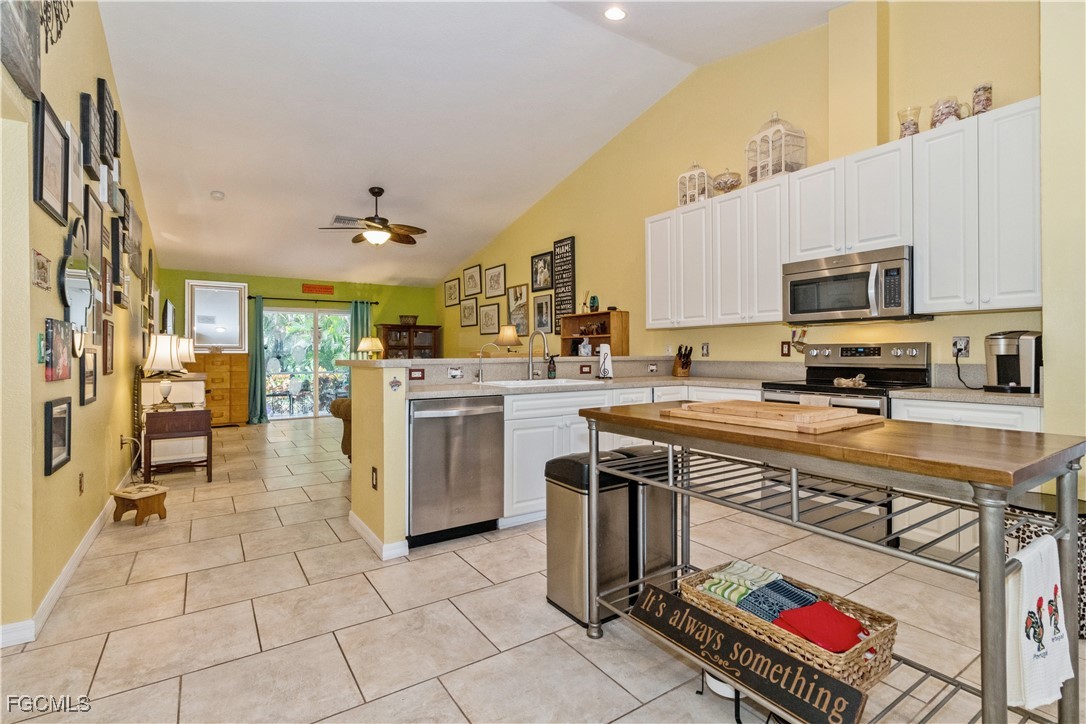 a kitchen with stainless steel appliances granite countertop a stove top oven a sink a counter top space and cabinets