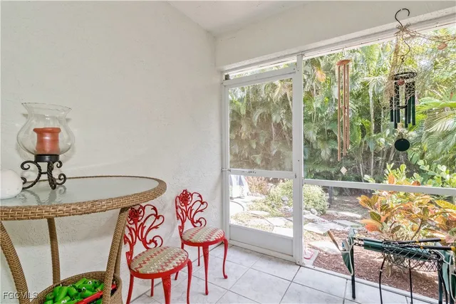 a dining room with furniture and a large window
