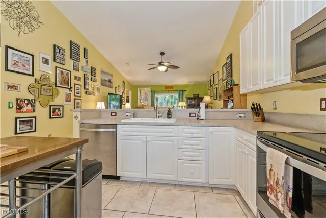 a kitchen with stainless steel appliances a stove sink and cabinets