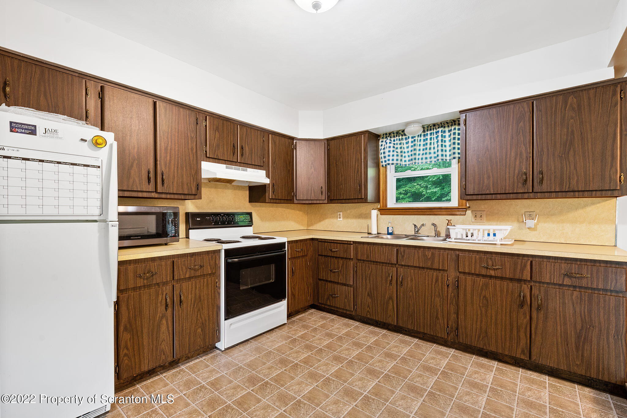 199 Spring Hill Road Moscow, PA 18444 - Photo 11 of 33 a kitchen with a sink stove and refrigerator