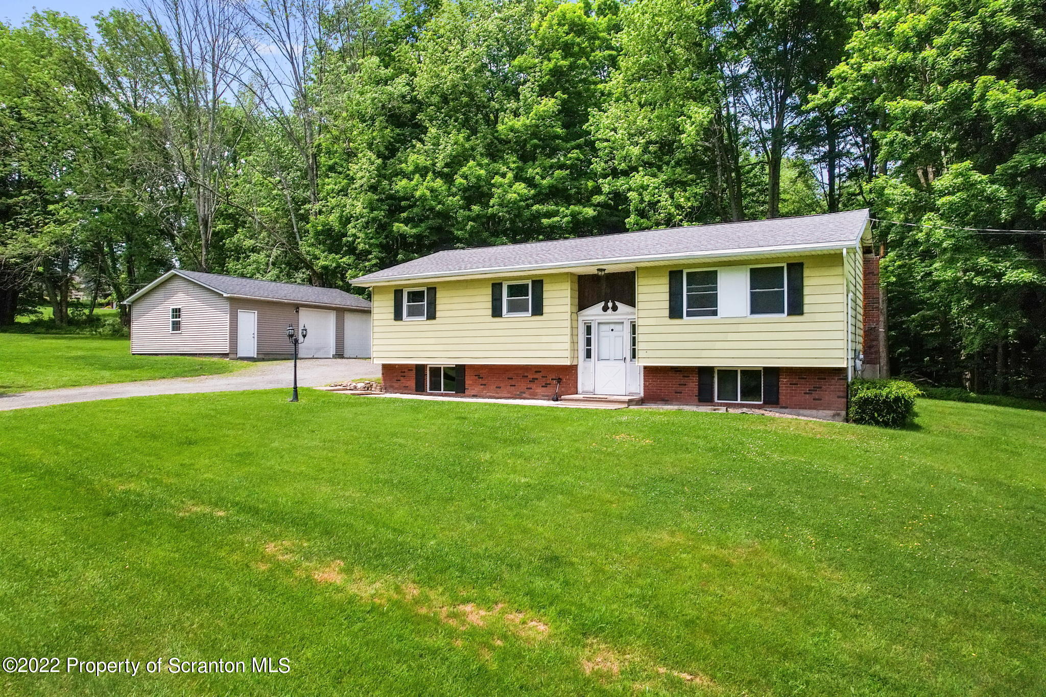 199 Spring Hill Road Moscow, PA 18444 - Photo 2 of 33 a front view of a house with a yard