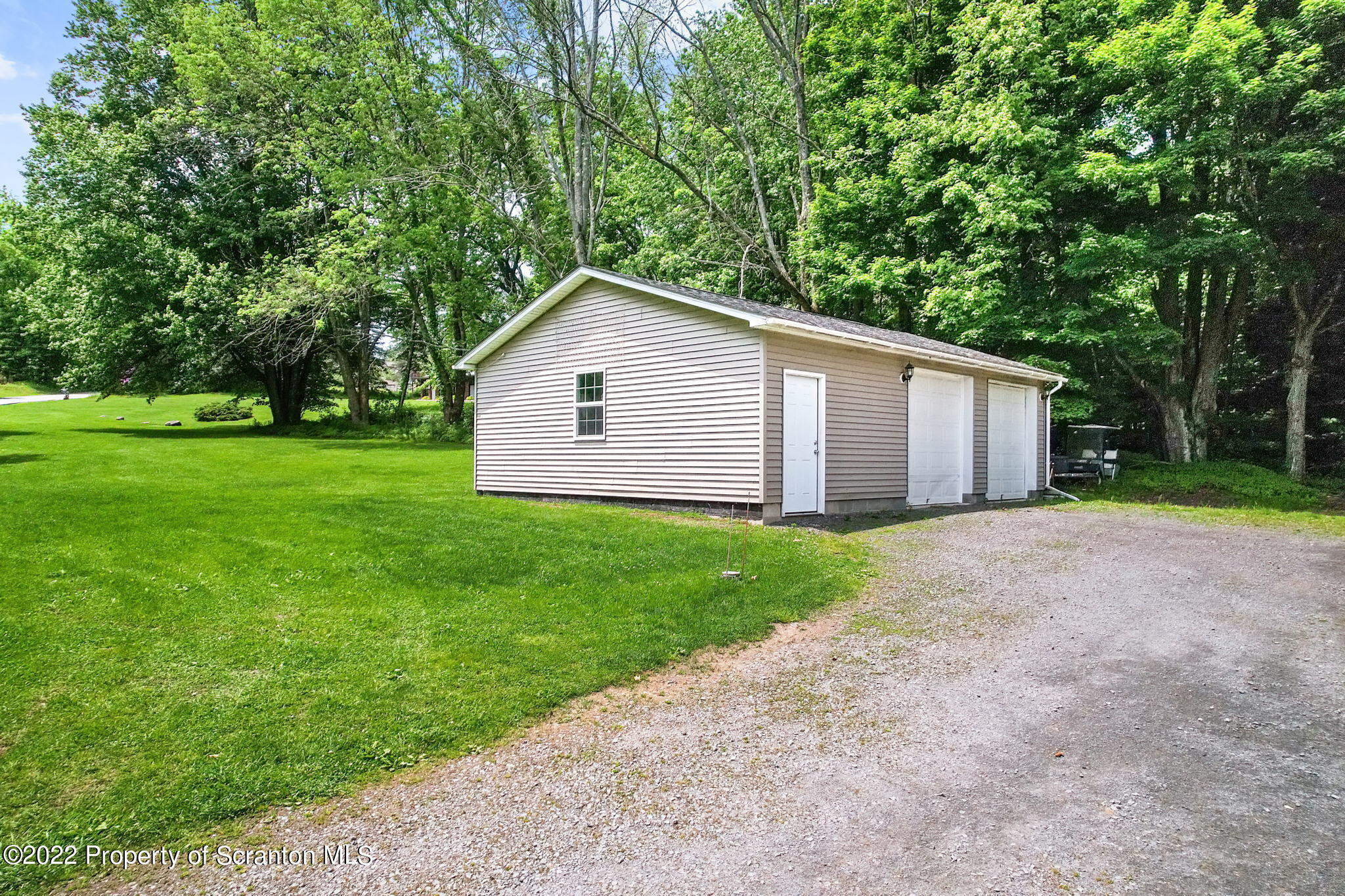 199 Spring Hill Road Moscow, PA 18444 - Photo 22 of 33 a view of a backyard with barn and large trees