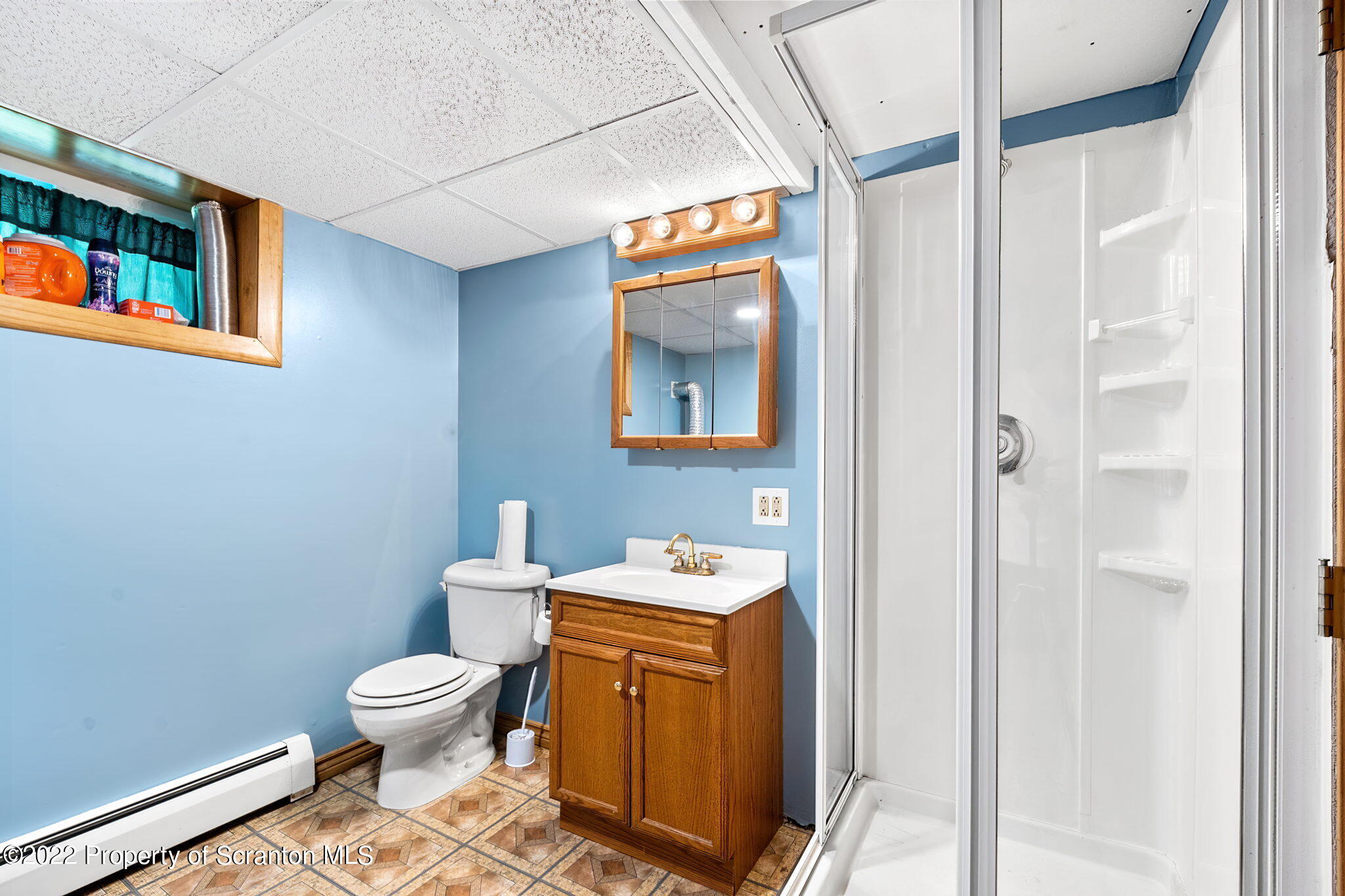 199 Spring Hill Road Moscow, PA 18444 - Photo 32 of 33 a bathroom with a sink a toilet and a mirror
