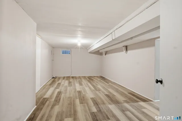 a view of a room with wooden floor