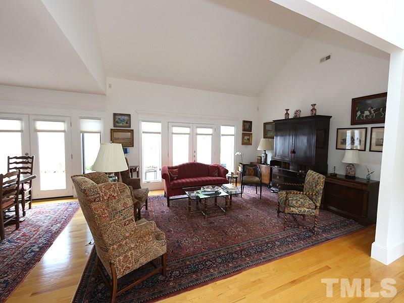 8501 Towneley Place Raleigh, NC 27615 - Photo 5 of 23 Vaulted beamed ceilings with doors opening to the private patio