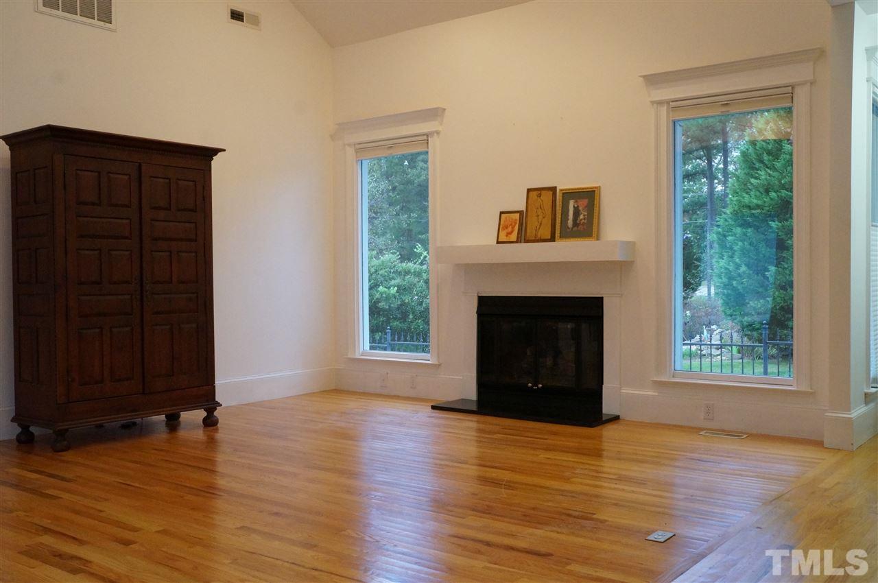 8501 Towneley Place Raleigh, NC 27615 - Photo 10 of 23 Family Room with French Doors to Courtyard, Vaulted Ceiling, Built-in Bookshelves.