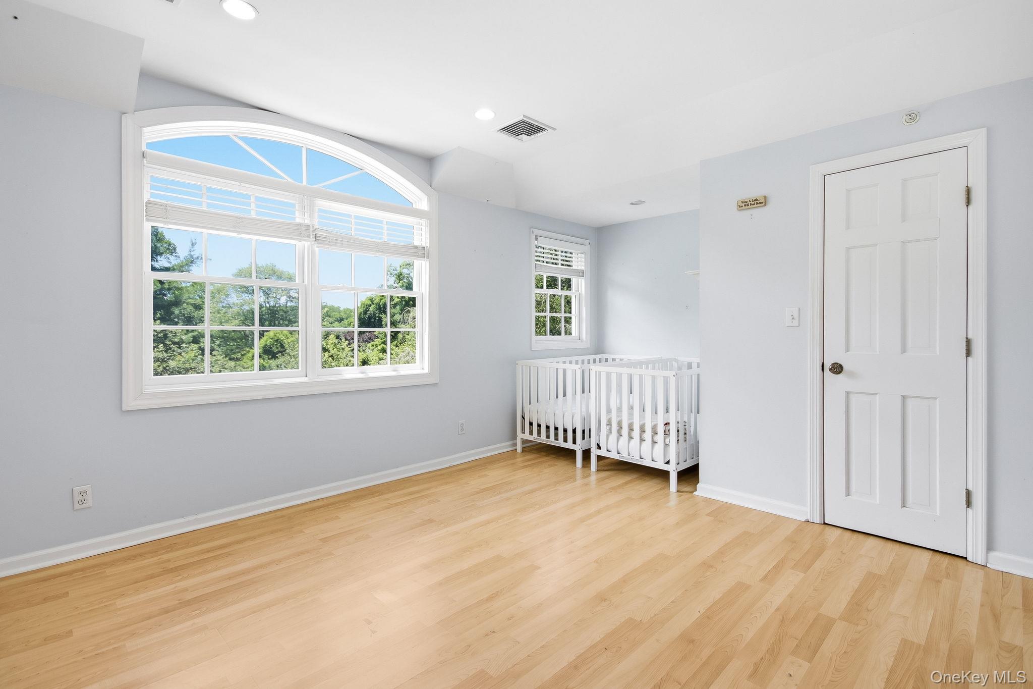 26 Century Ridge Road Purchase, NY 10577 - Photo 24 of 50 Upstairs Bedroom #4: Room with light wood-finish flooring and light blue walls