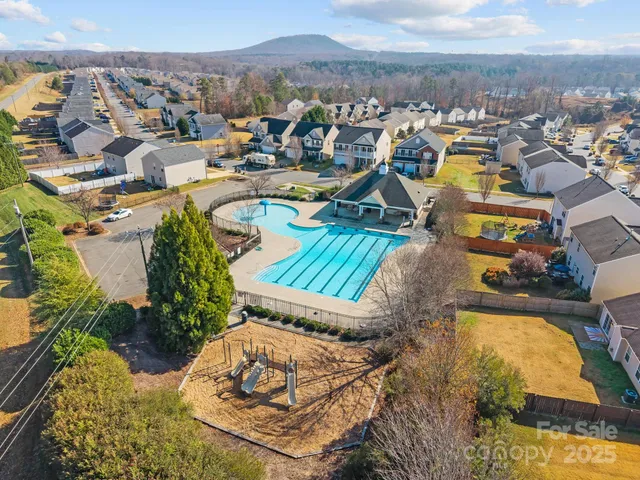 an aerial view of a house with a swimming pool