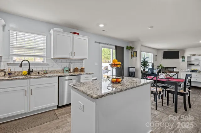 a kitchen with stainless steel appliances granite countertop a refrigerator stove microwave and sink